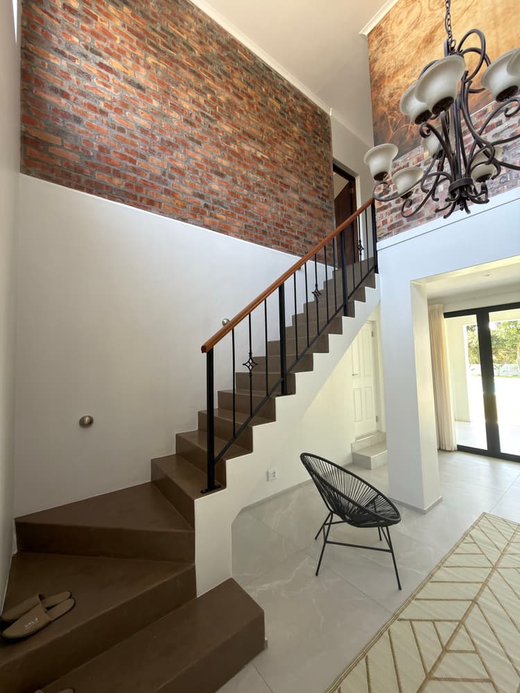Staircase with brick wall